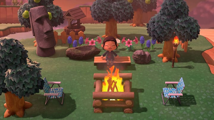 image of in game conten with character sitting at bonfire